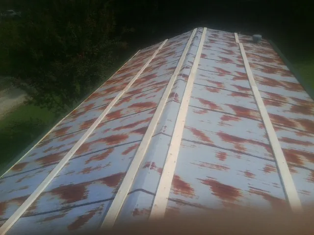 Rusted metal roof panels with new wood purlins before replacement — Storm Damage Roof Repair in Yorktown by Roofing Brothers