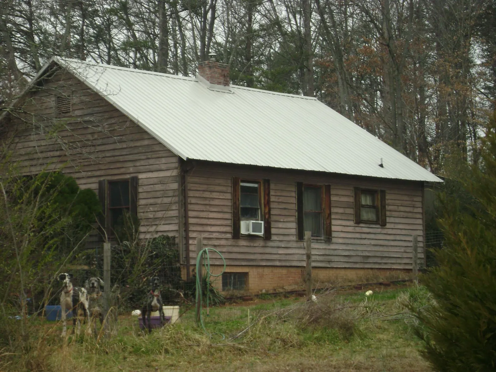 White metal roof on an old wood sided farmhouse, from a Metal Roof Installation job in Yorktown